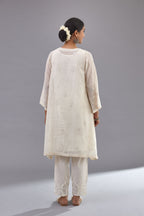 Off-white cotton chanderi A-line kurta set with all-over assorted flowers embroidery, highlighted with sequins handwork.