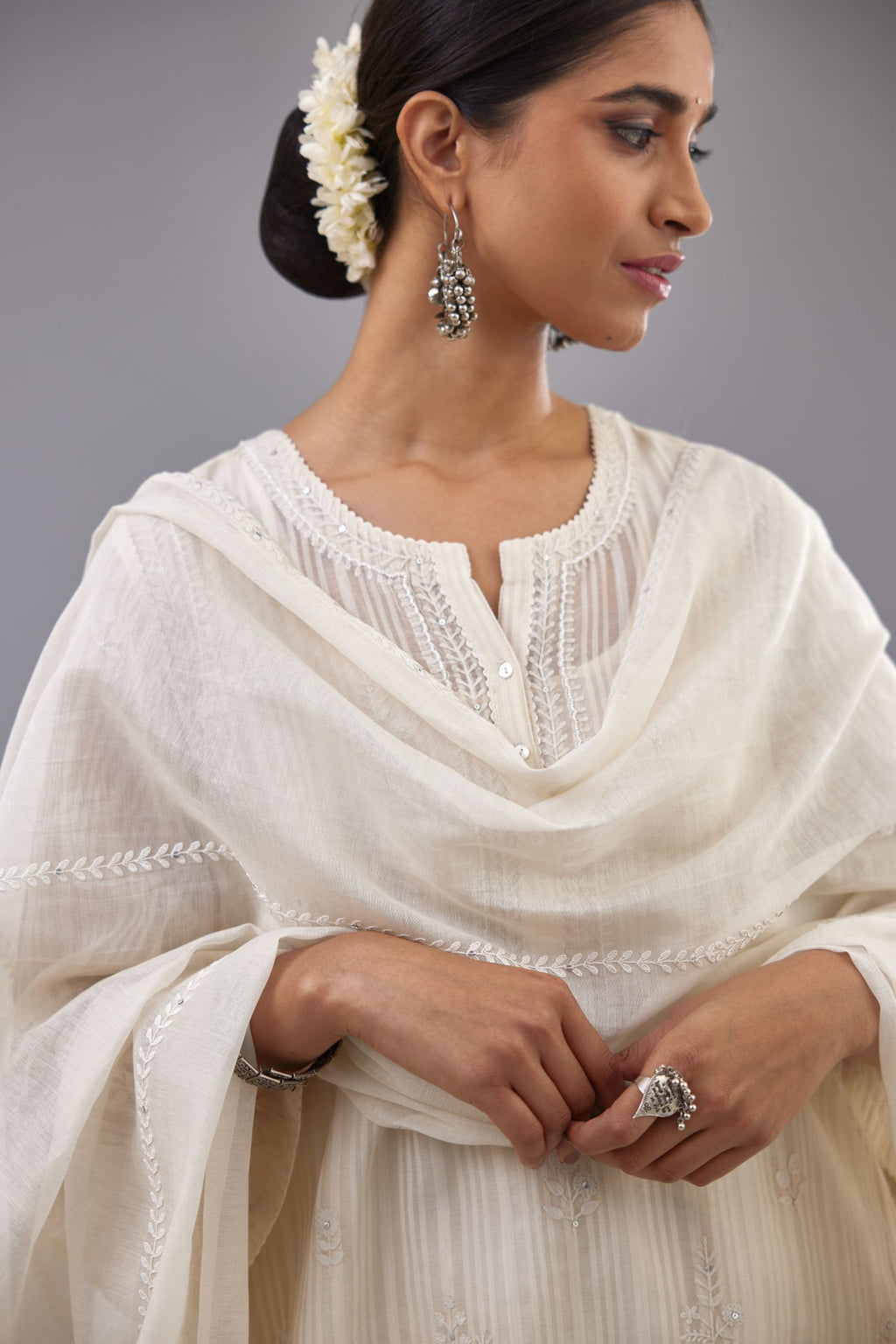 Off-white cotton chanderi A-line kurta set with all-over assorted flowers embroidery, highlighted with sequins handwork.
