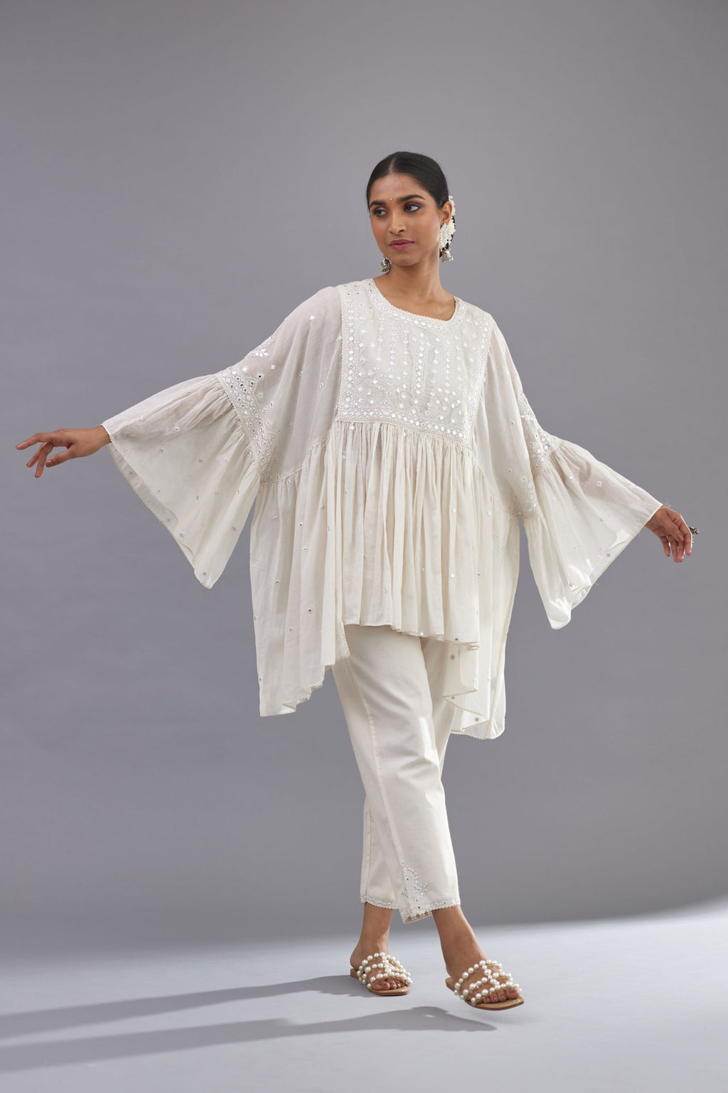 Off white cotton easy fit top with flared sleeves and hem, paired with off white cotton comfortable fit pant with all-over elasticated waistband.