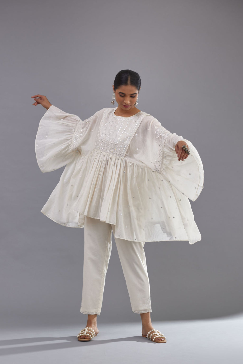 Off white cotton easy fit top with flared sleeves and hem, paired with off white cotton comfortable fit pant with all-over elasticated waistband.