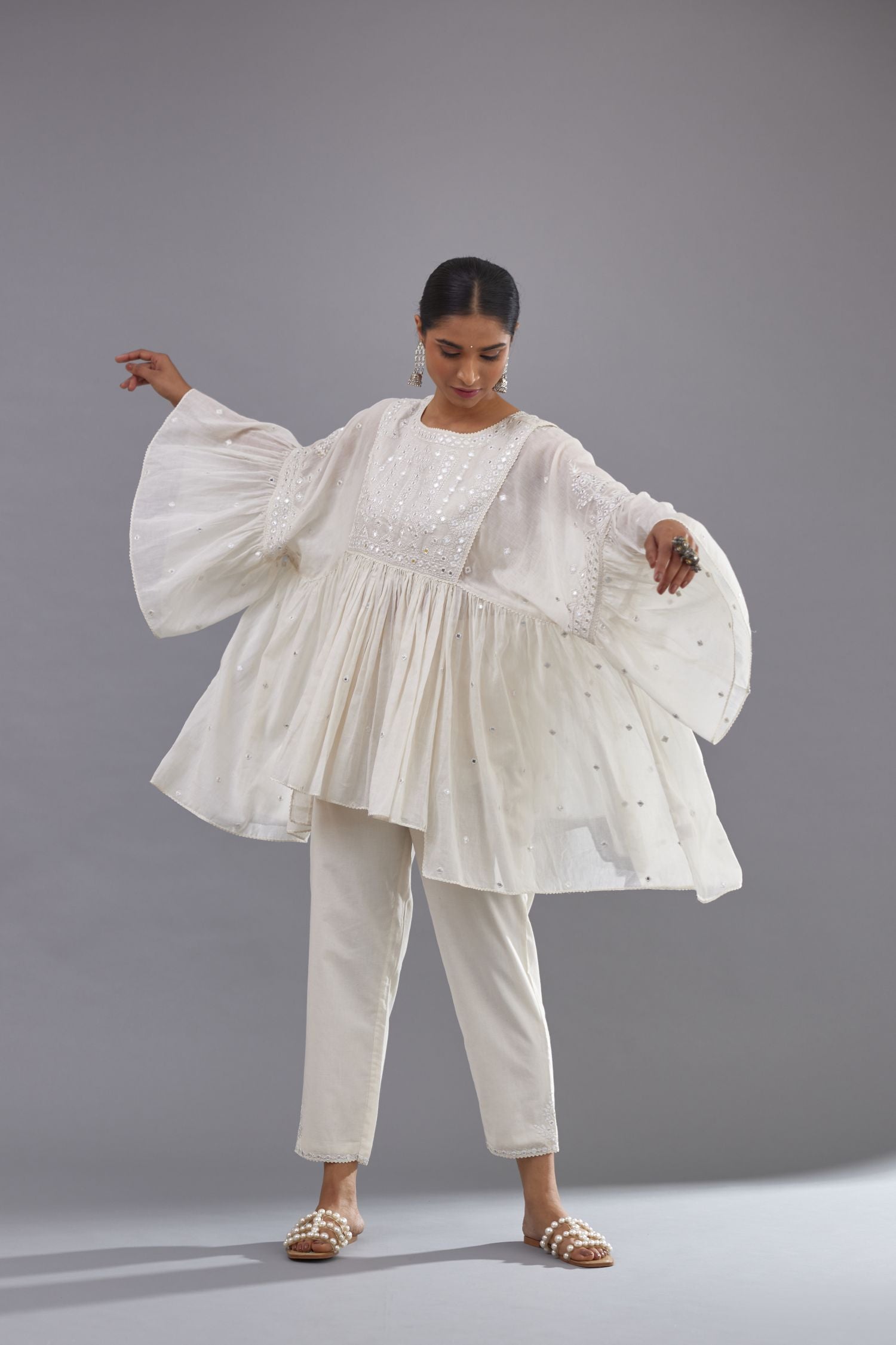 Off white cotton easy fit top with flared sleeves and hem, paired with off white cotton comfortable fit pant with all-over elasticated waistband.