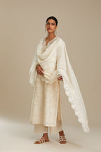 Off white silk chanderi straight kurta set with graded leaf appliqué and sequin detail at edges.