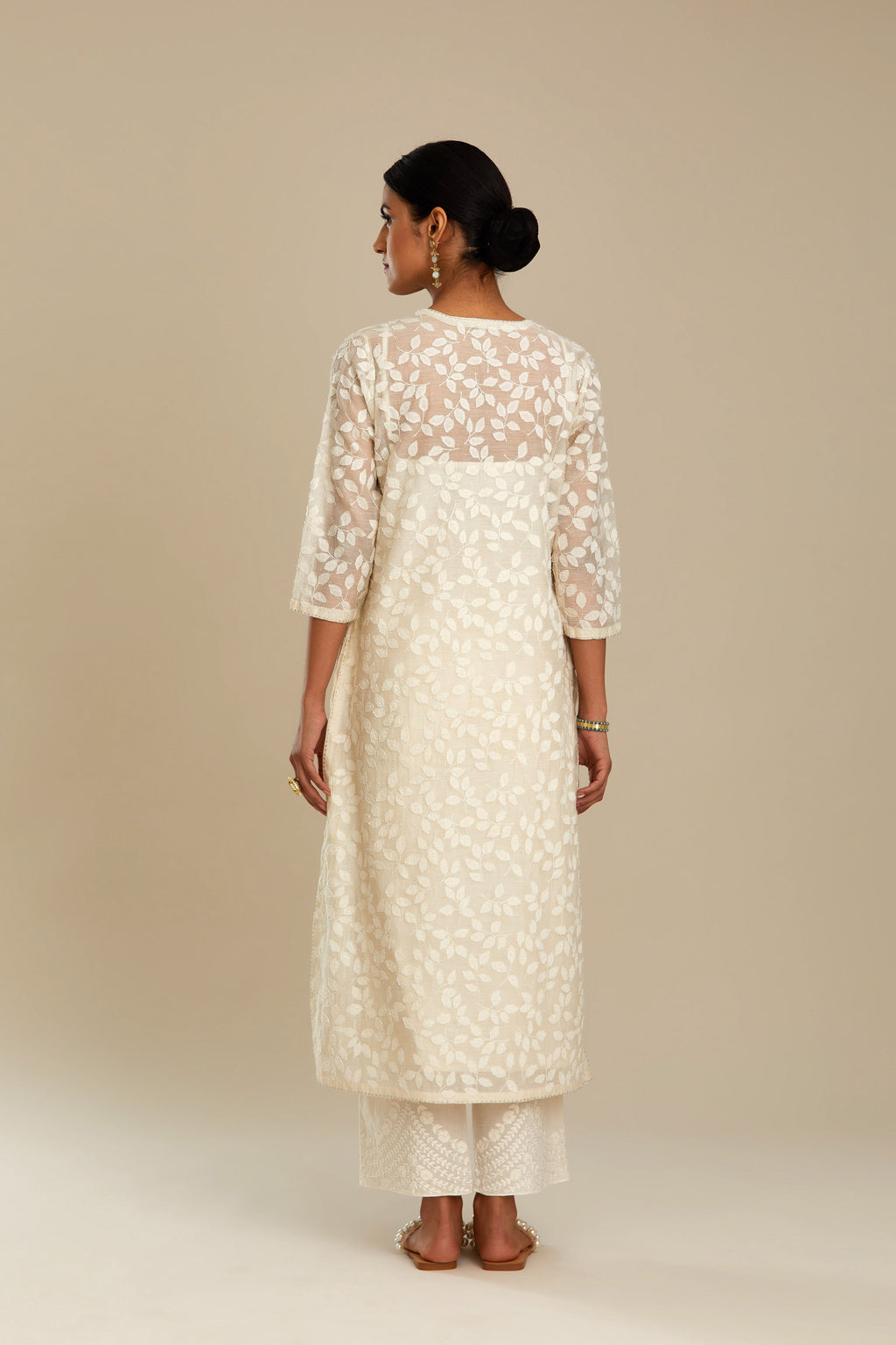 Off white silk chanderi straight kurta set with all-over leaf appliqué and sequins at edges.