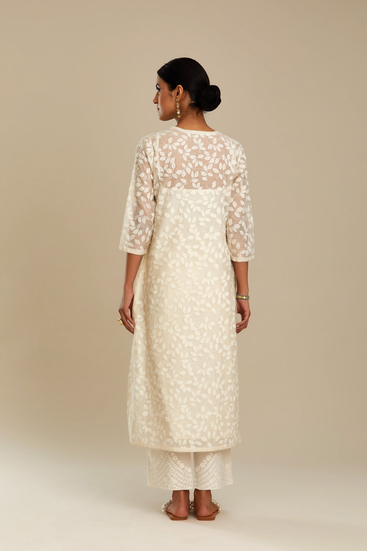 Off white silk chanderi straight kurta set with all-over leaf appliqué and sequins at edges.