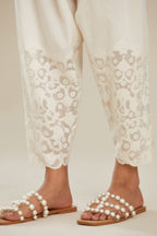 Off white cotton narrow salwar with appliqué and hand attached sequins detailing. (Salwar)