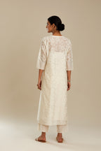 Off white silk chanderi straight kurta set with floral appliqué in center panel and striped cutwork at the sides.
