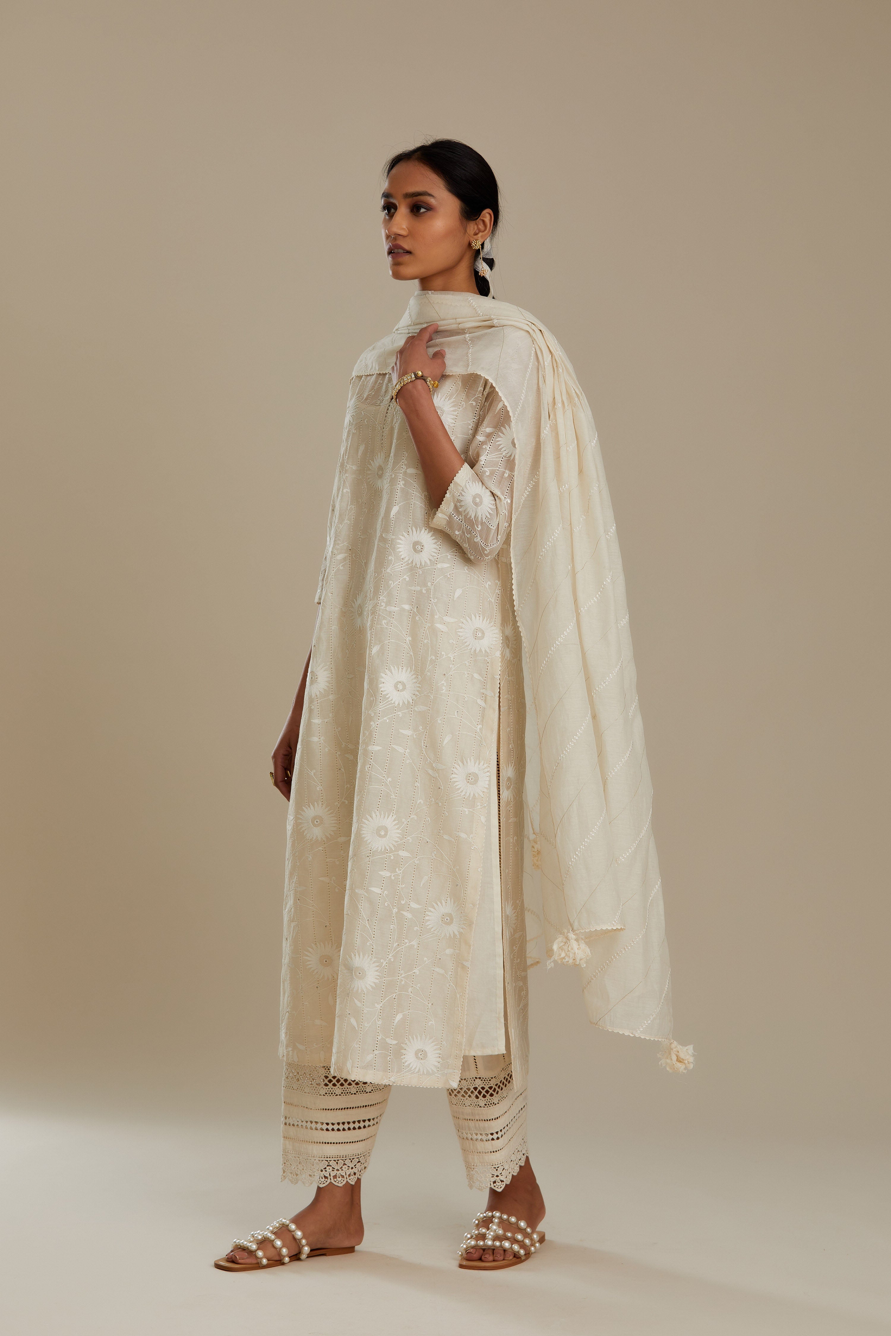 Silk chanderi straight kurta set with all-over faggoting overlayed with floral jaal threadwork, highlighted with sequins.