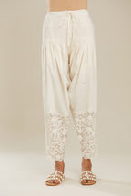 Off white cotton narrow salwar with appliqué and hand attached sequins detailing. (Salwar)
