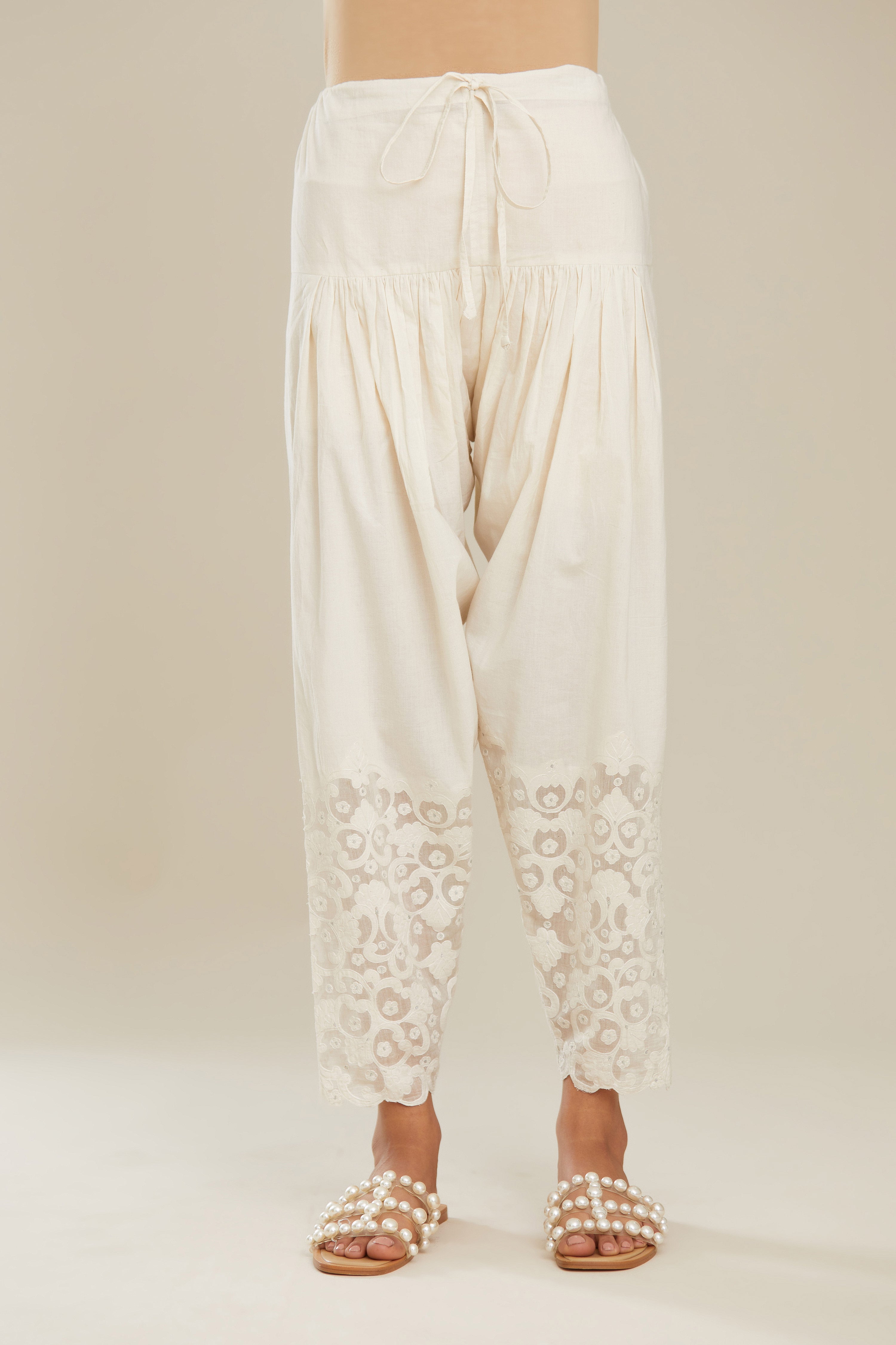 Off white cotton narrow salwar with appliqué and hand attached sequins detailing. (Salwar)