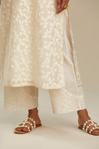 Off white silk chanderi straight kurta set with all-over leaf appliqué and sequins at edges.