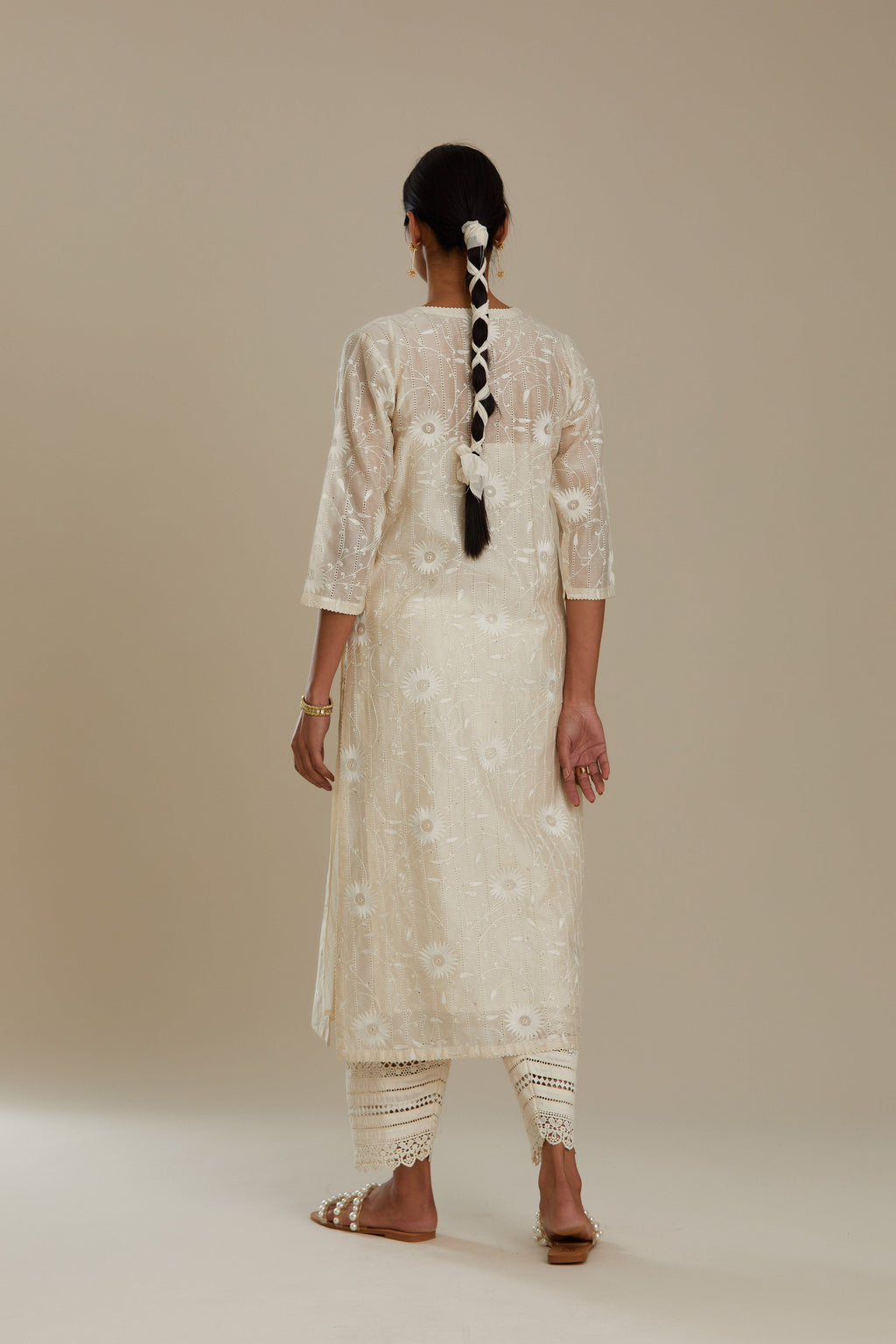 Silk chanderi straight kurta set with all-over faggoting overlayed with floral jaal threadwork, highlighted with sequins.
