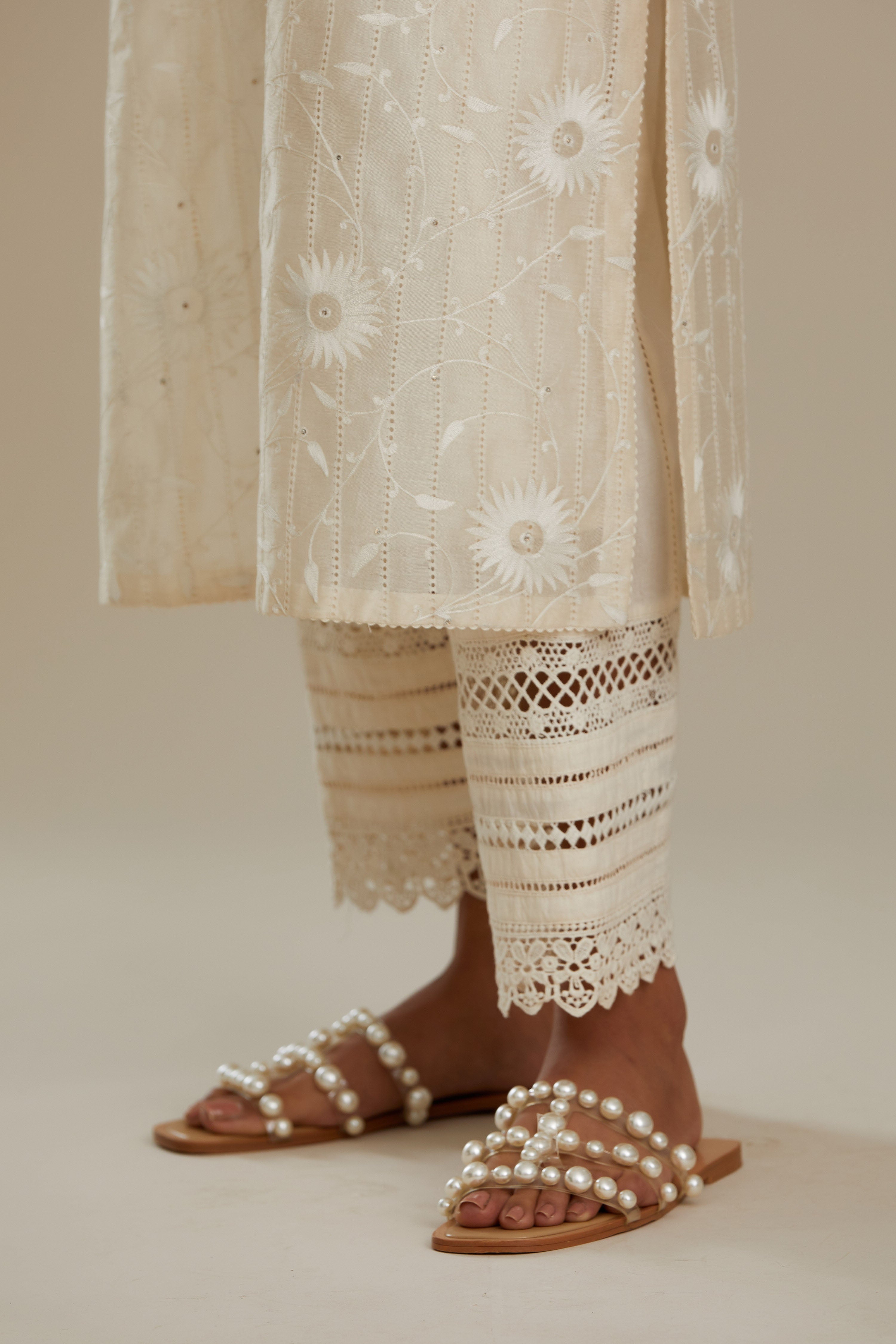 Silk chanderi straight kurta set with all-over faggoting overlayed with floral jaal threadwork, highlighted with sequins.