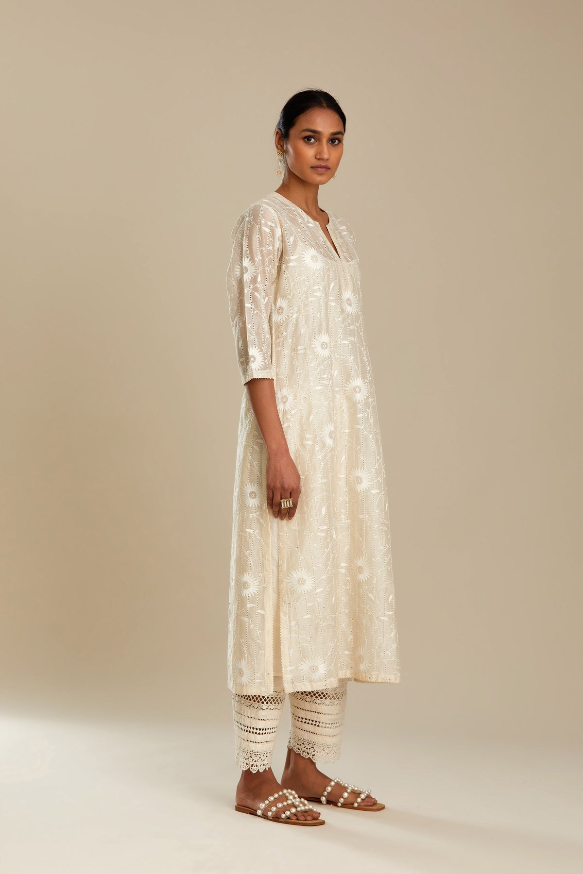 Silk chanderi straight kurta set with all-over faggoting overlayed with floral jaal threadwork, highlighted with sequins.