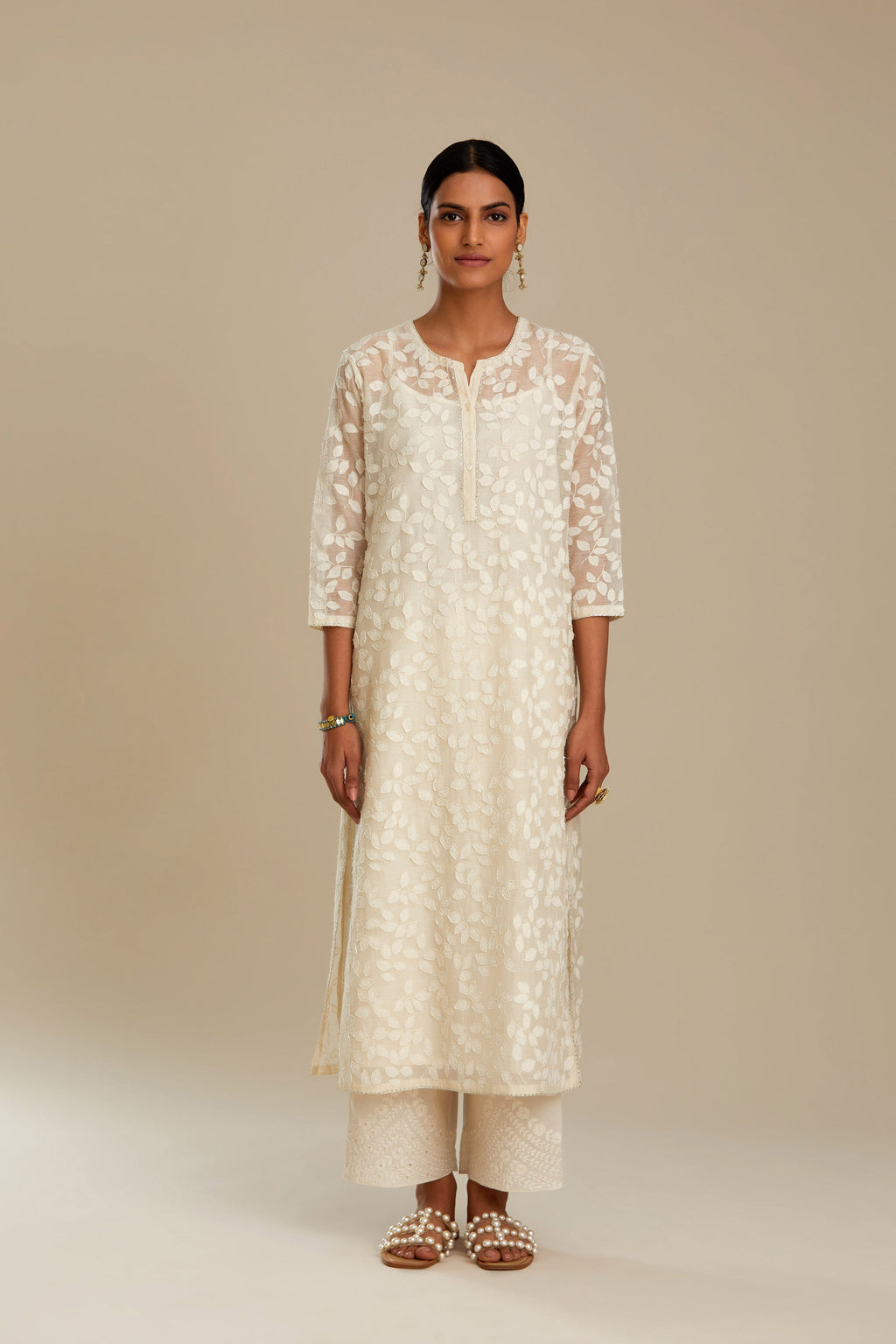 Off white silk chanderi straight kurta set with all-over leaf appliqué and sequins at edges.