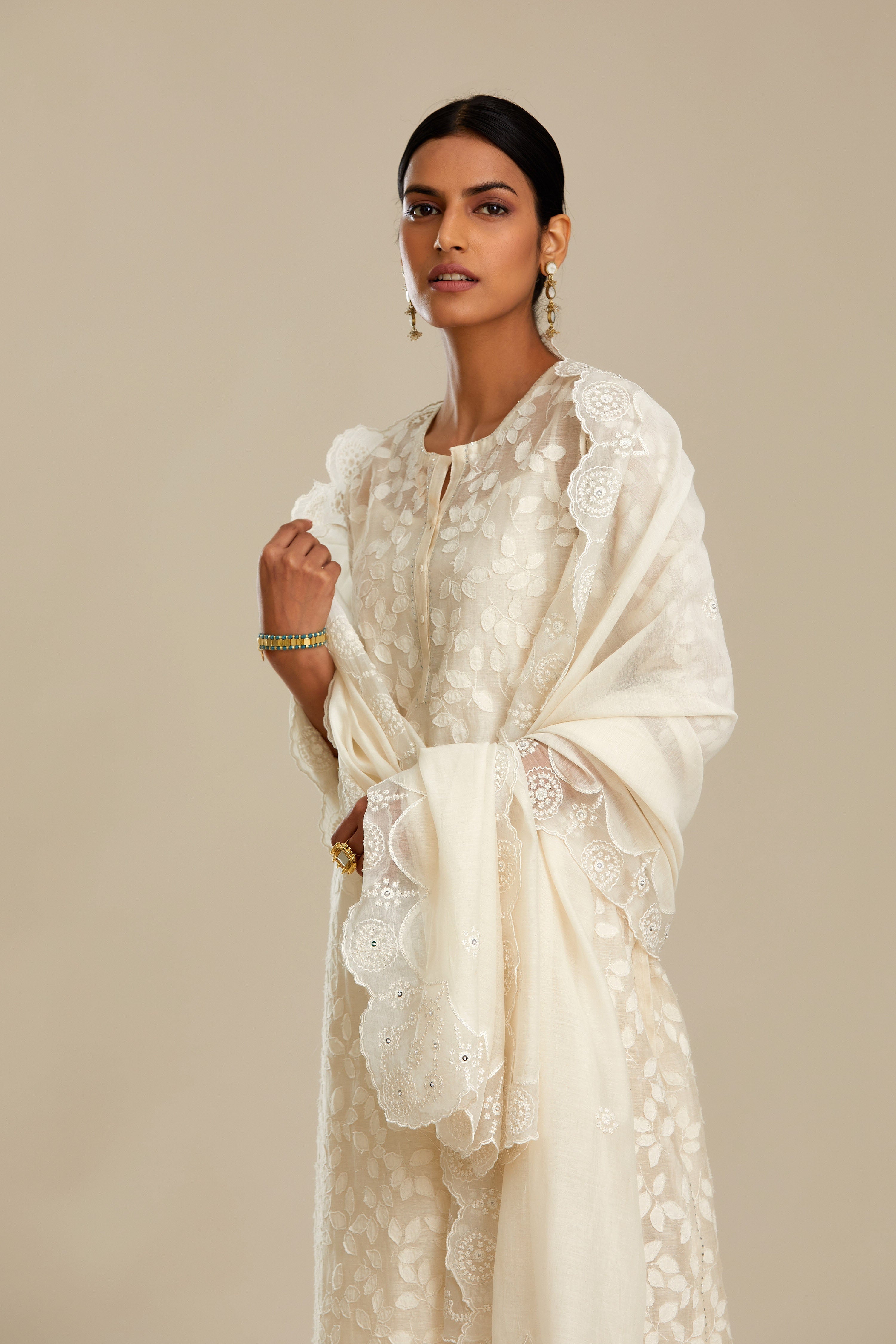 Off white silk chanderi straight kurta set with all-over leaf appliqué and sequins at edges.