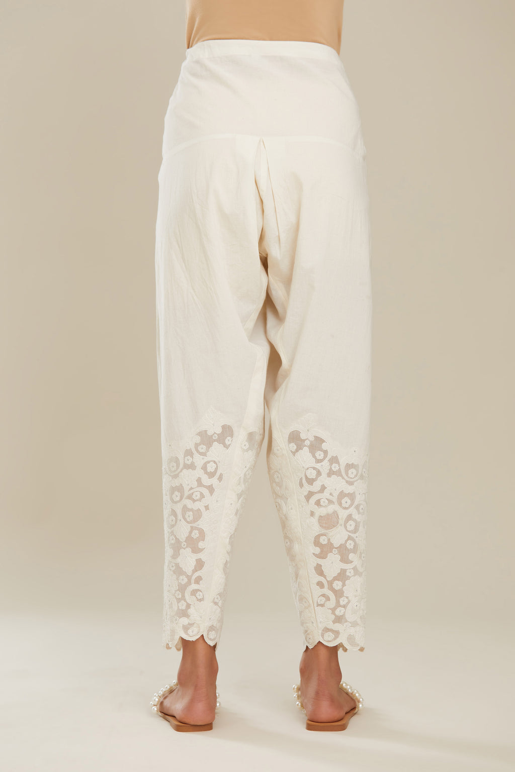 Off white cotton narrow salwar with appliqué and hand attached sequins detailing. (Salwar)