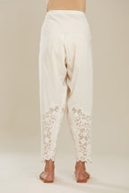Off white cotton narrow salwar with appliqué and hand attached sequins detailing. (Salwar)