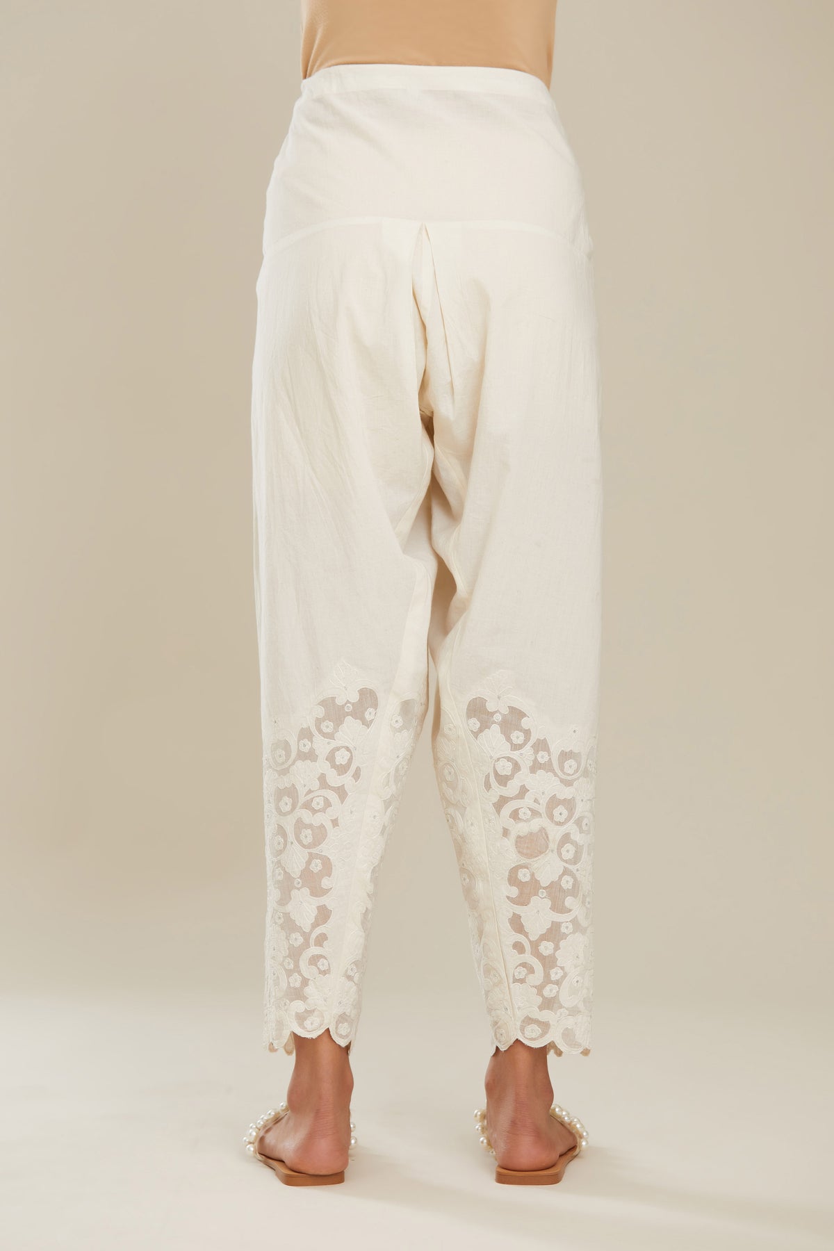 Off white cotton narrow salwar with appliqué and hand attached sequins detailing. (Salwar)