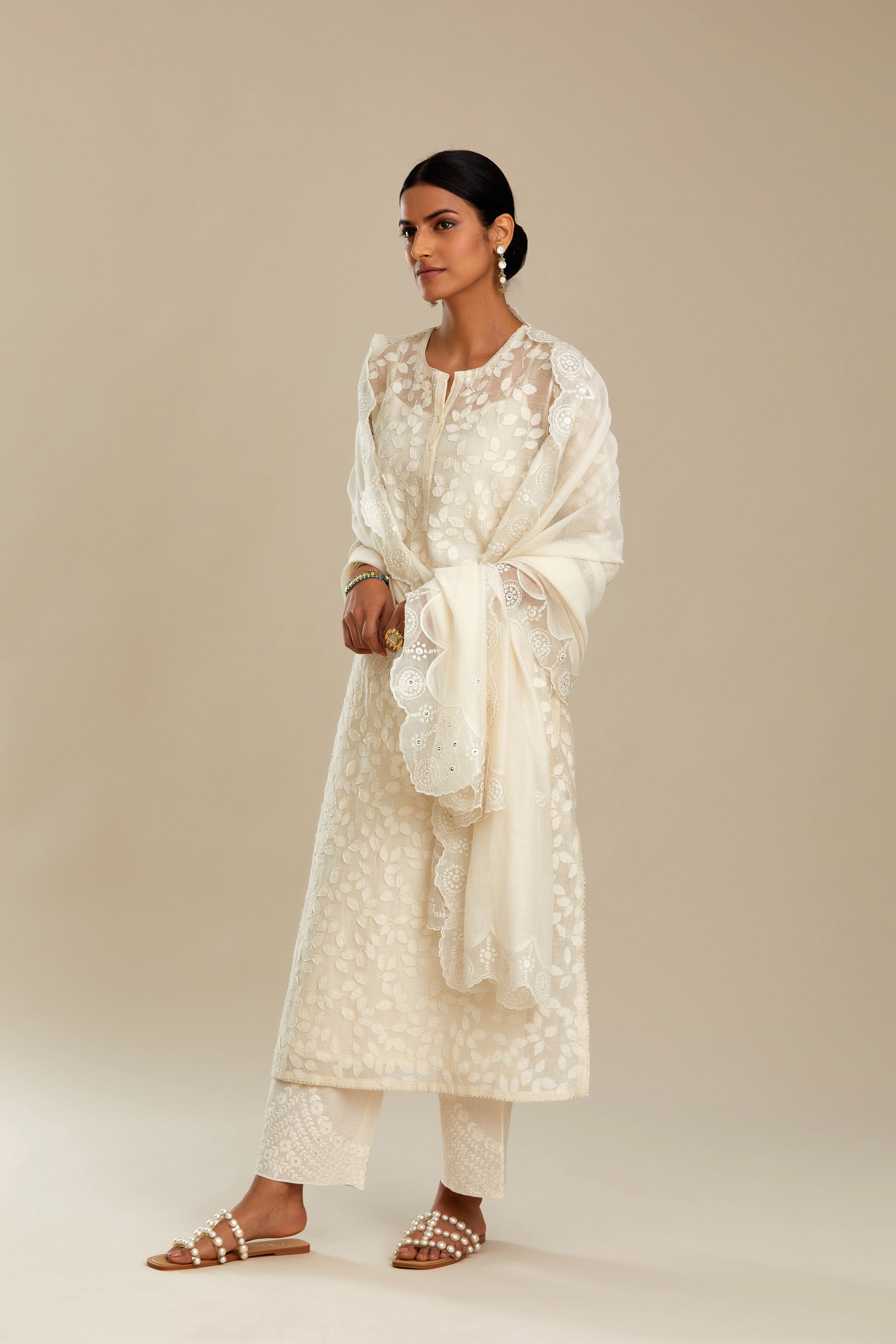 Off white silk chanderi straight kurta set with all-over leaf appliqué and sequins at edges.