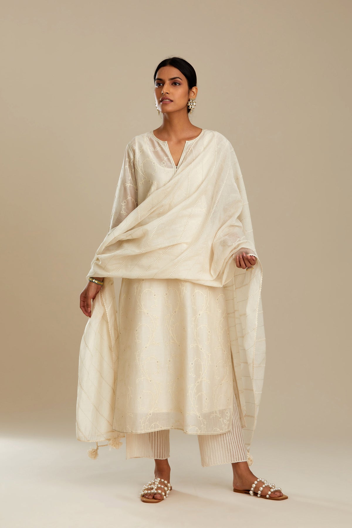 Off white silk chanderi straight kurta set with all-over tonal silk thread embroidery.