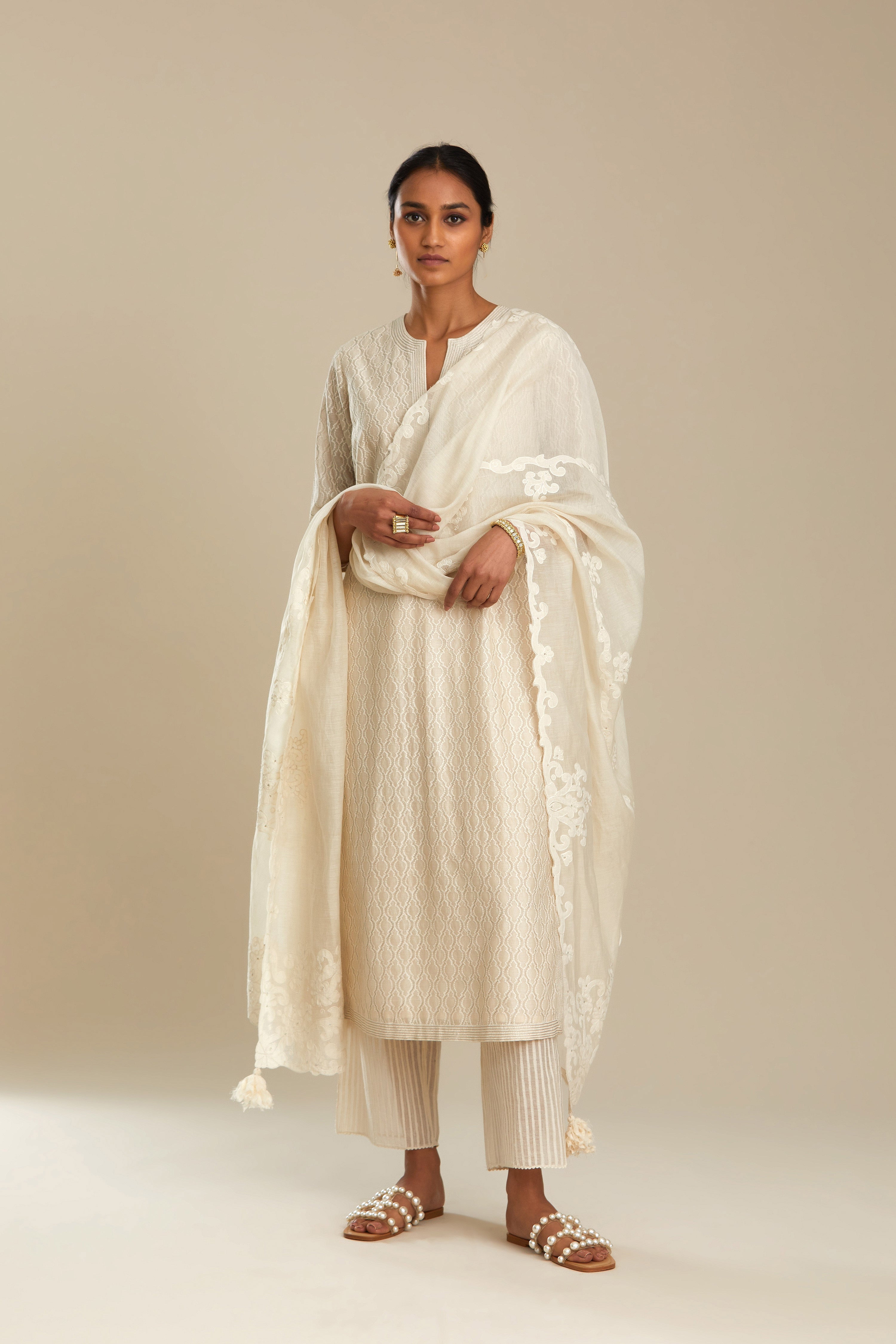 Off white silk chanderi straight kurta set with all-over jharoka jaal embroidery.