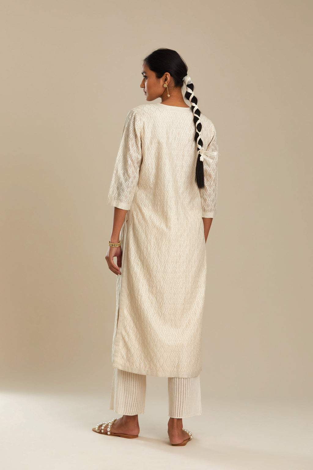 Off white silk chanderi straight kurta set with all-over jharoka jaal embroidery.