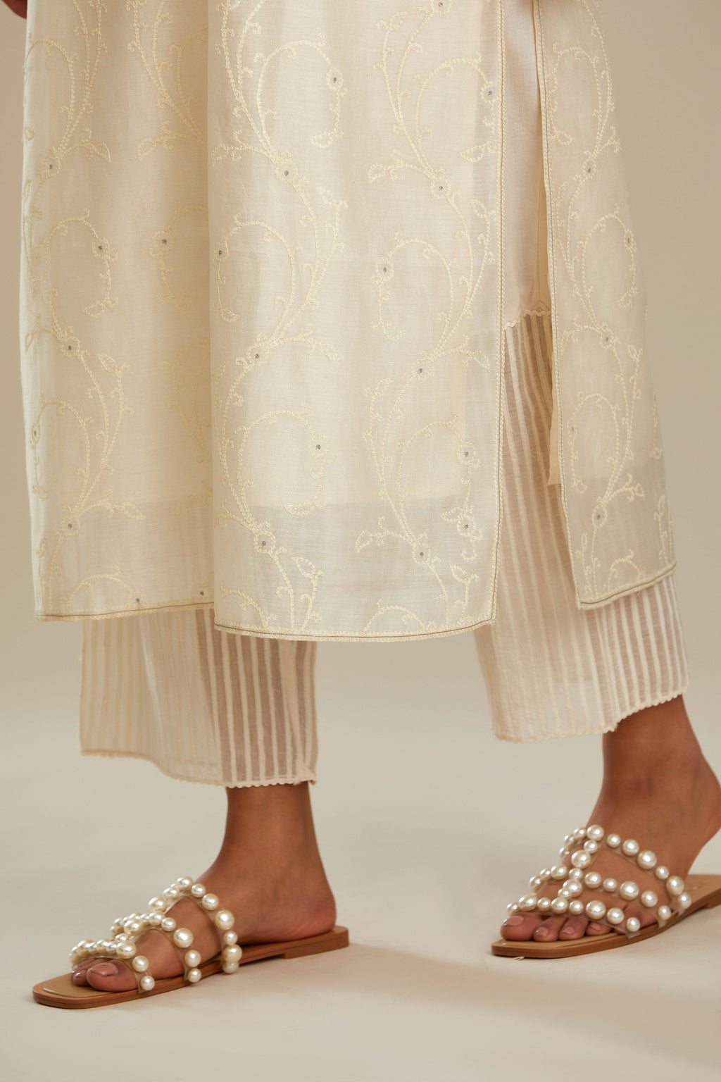 Off white silk chanderi straight kurta set with all-over tonal silk thread embroidery.