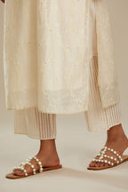 Off white silk chanderi straight kurta set with all-over tonal silk thread embroidery.