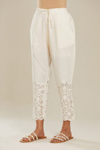 Off white cotton narrow pants with appliqué and hand attached sequins detailing. (Pants)