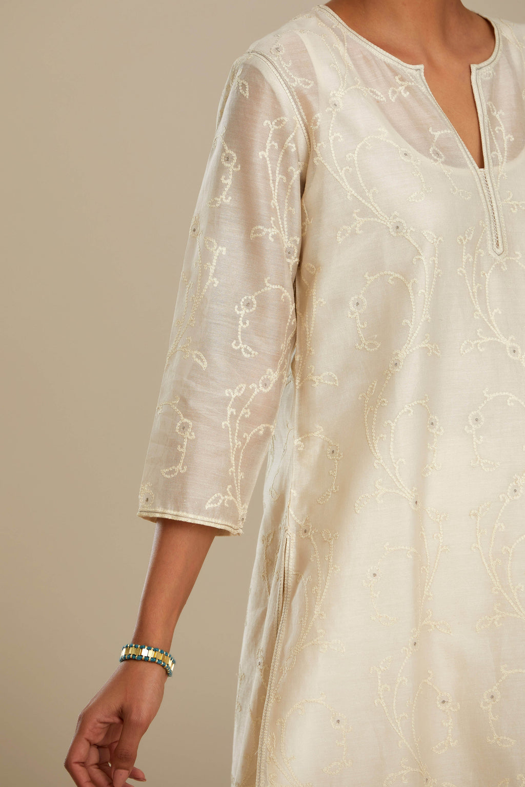Off white silk chanderi straight kurta set with all-over tonal silk thread embroidery.