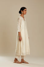 Off white silk chanderi straight kurta set with all-over tonal silk thread embroidery.
