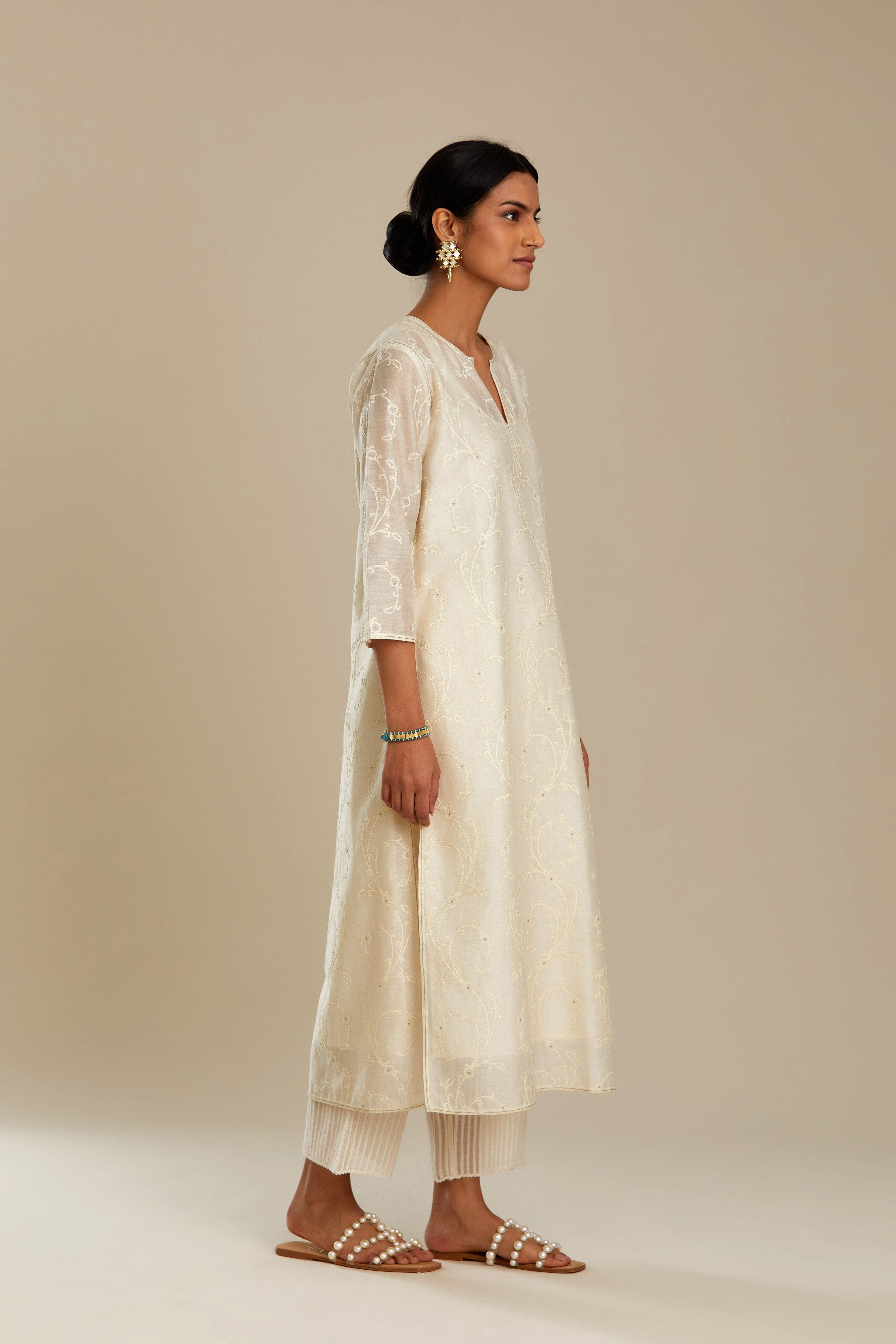 Off white silk chanderi straight kurta set with all-over tonal silk thread embroidery.