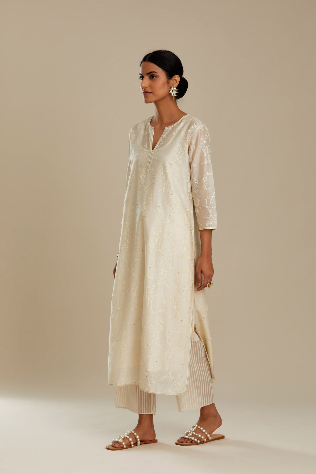 Off white silk chanderi straight kurta set with all-over tonal silk thread embroidery.