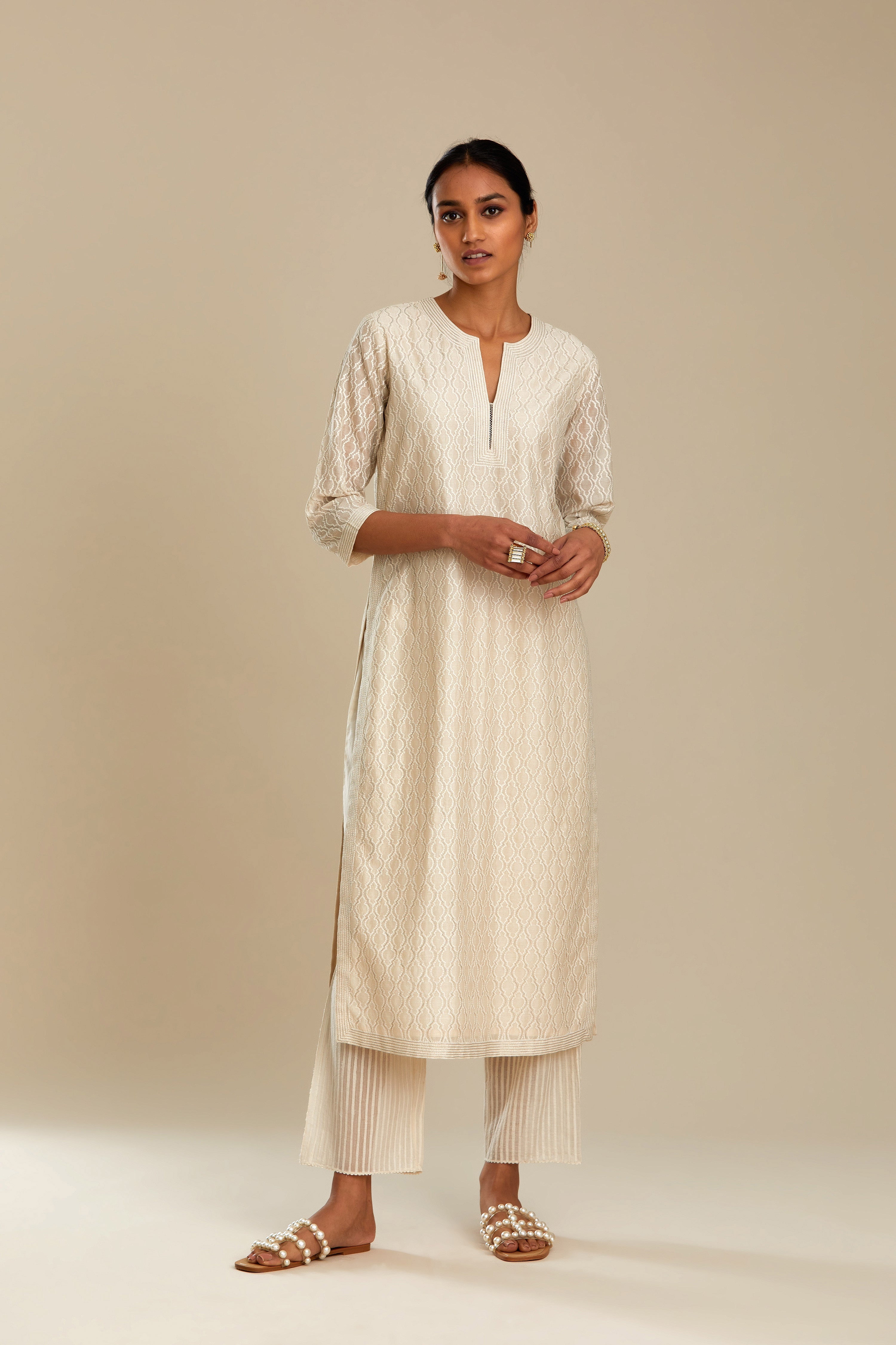 Off white silk chanderi straight kurta set with all-over jharoka jaal embroidery.