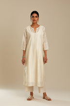 Off white silk chanderi straight kurta set with all-over tonal silk thread embroidery.
