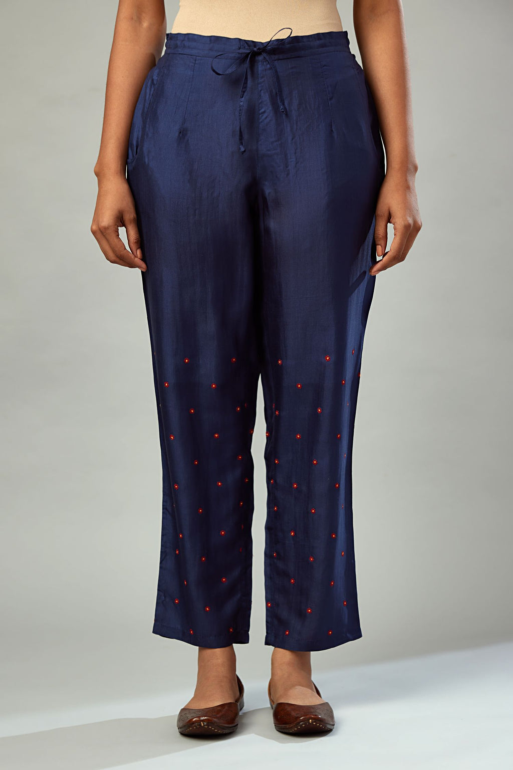 Indigo silk straight pants detailed with small flower embroidery at bottom.