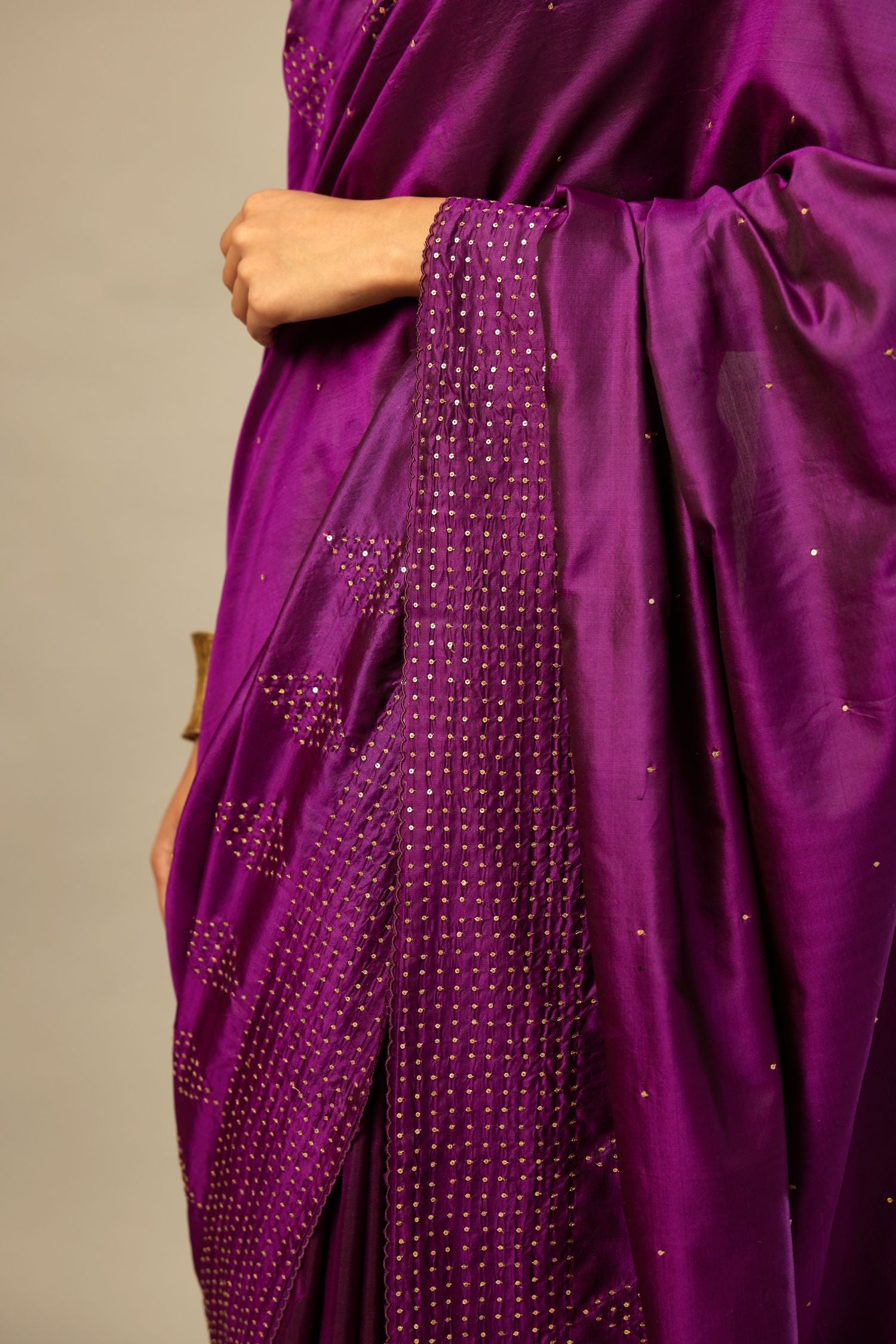 Plum purple silk saree set with a broad sequin border with diamond motifs.