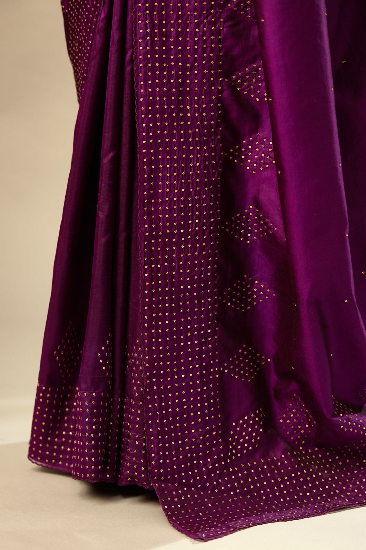 Plum purple silk saree set with a broad sequin border with diamond motifs.