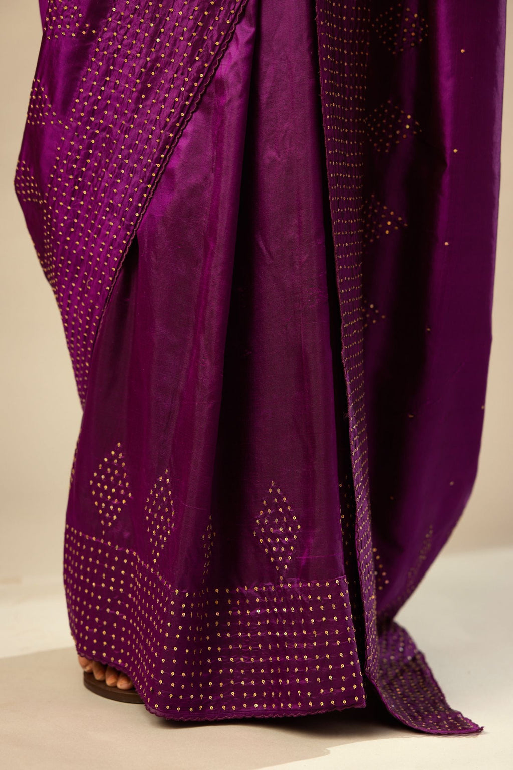 Plum purple silk saree set with a broad sequin border with diamond motifs.