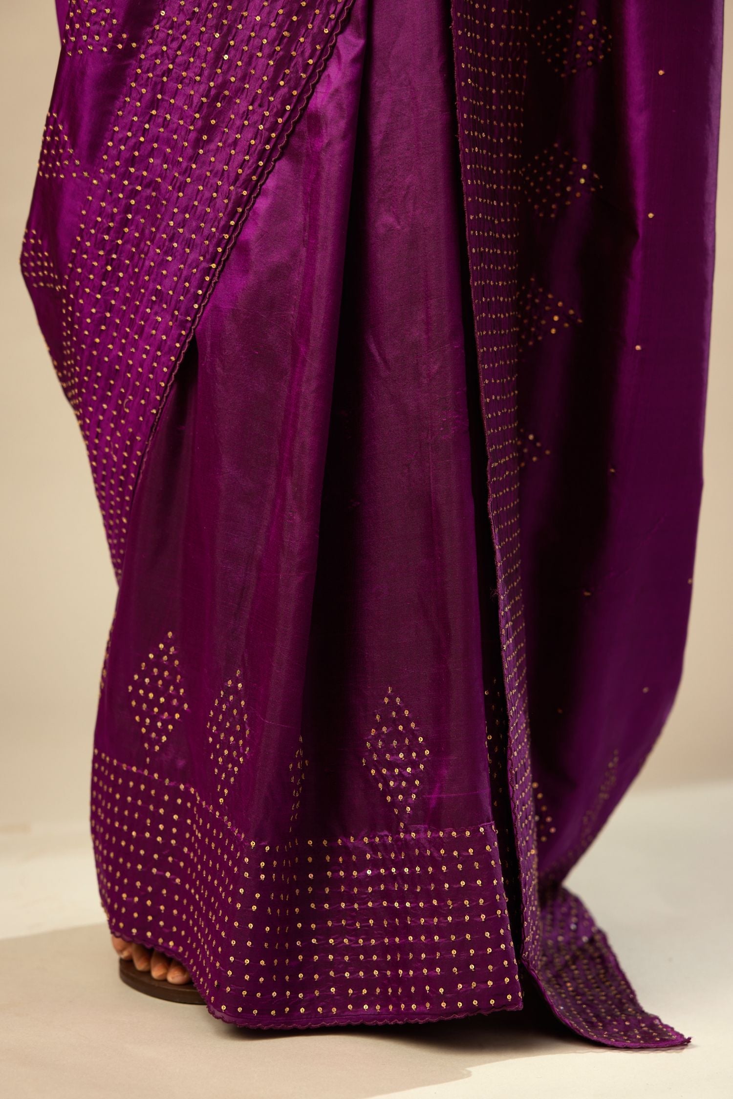 Plum purple silk saree set with a broad sequin border with diamond motifs.
