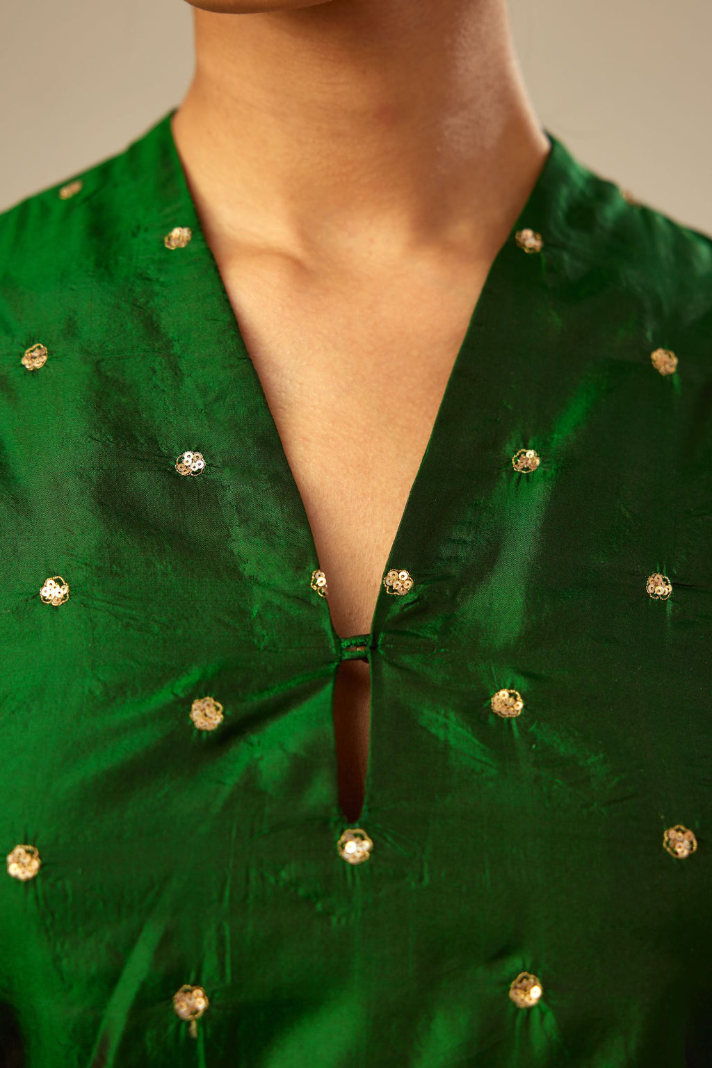 Dark green silk easy fit blouse with a raised V neck and all-over delicate hand embroidered sequins flowers.