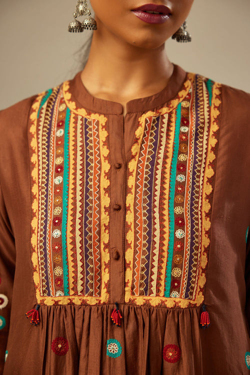A four piece set in Brown silk comprising of a short kurta with