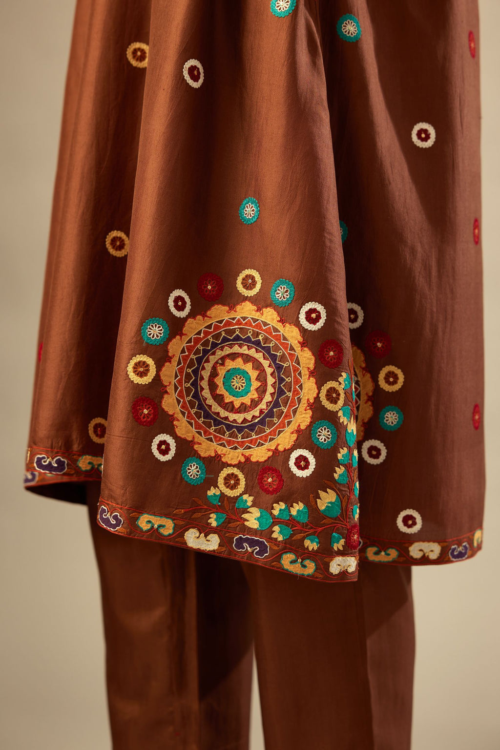 Brown silk short V-neck kurta set, with straight hem and side pockets, decorated with fine appliqué and aari thread embroidery.