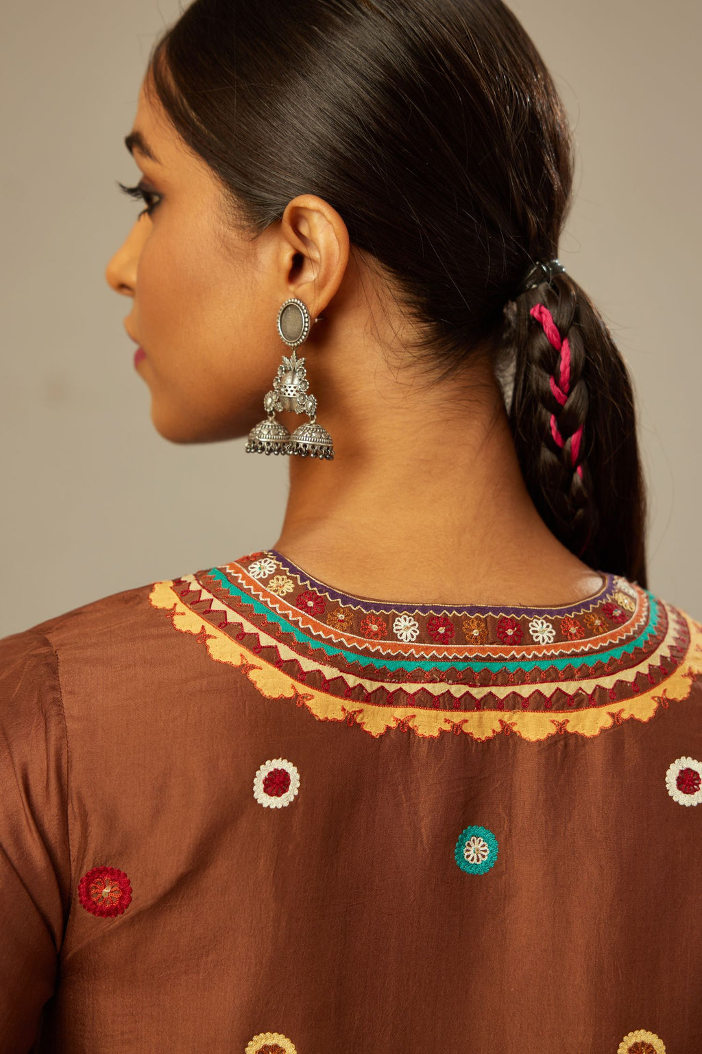 Brown silk short V-neck kurta set, with straight hem and side pockets, decorated with fine appliqué and aari thread embroidery.