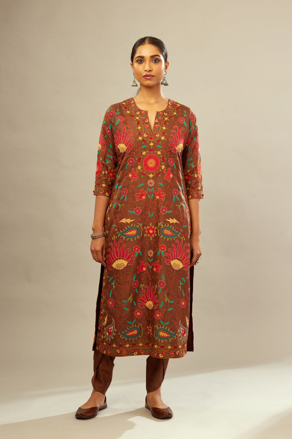 Brown straight kurta set, fully embroidered with bold appliqué flowers, multi-colored aari threadwork and silk tassels.