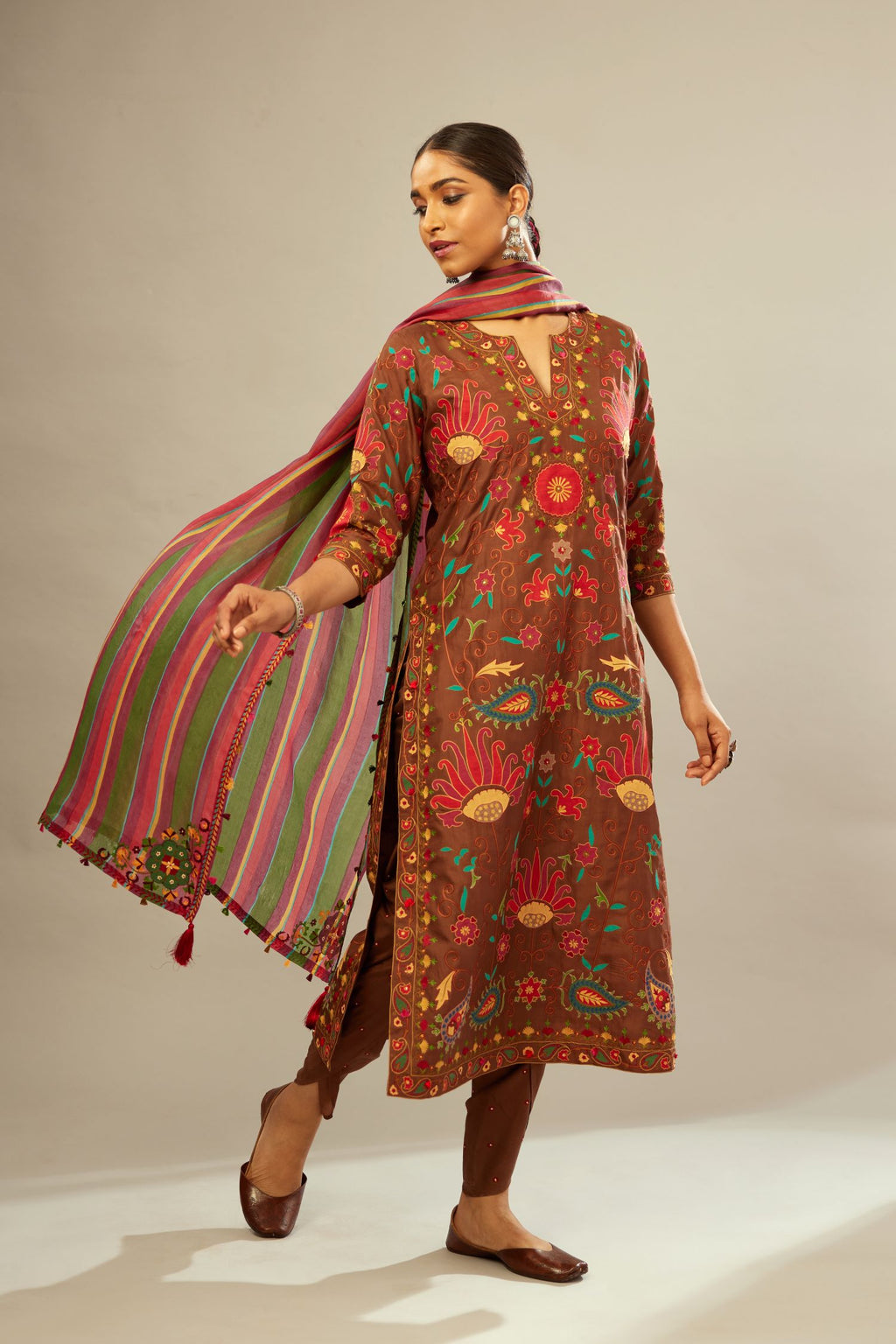 Brown straight kurta set, fully embroidered with bold appliqué flowers, multi-colored aari threadwork and silk tassels.