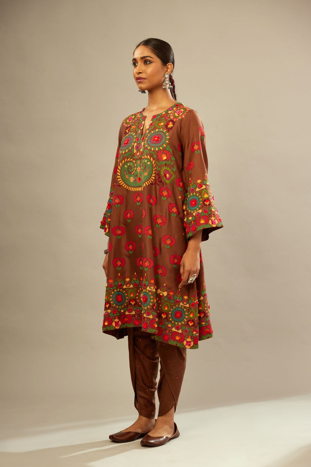 Brown silk straight hem mid-length abha style kurta set with bold appliqué embroidery along with multi-colored aari thread work and tassels.