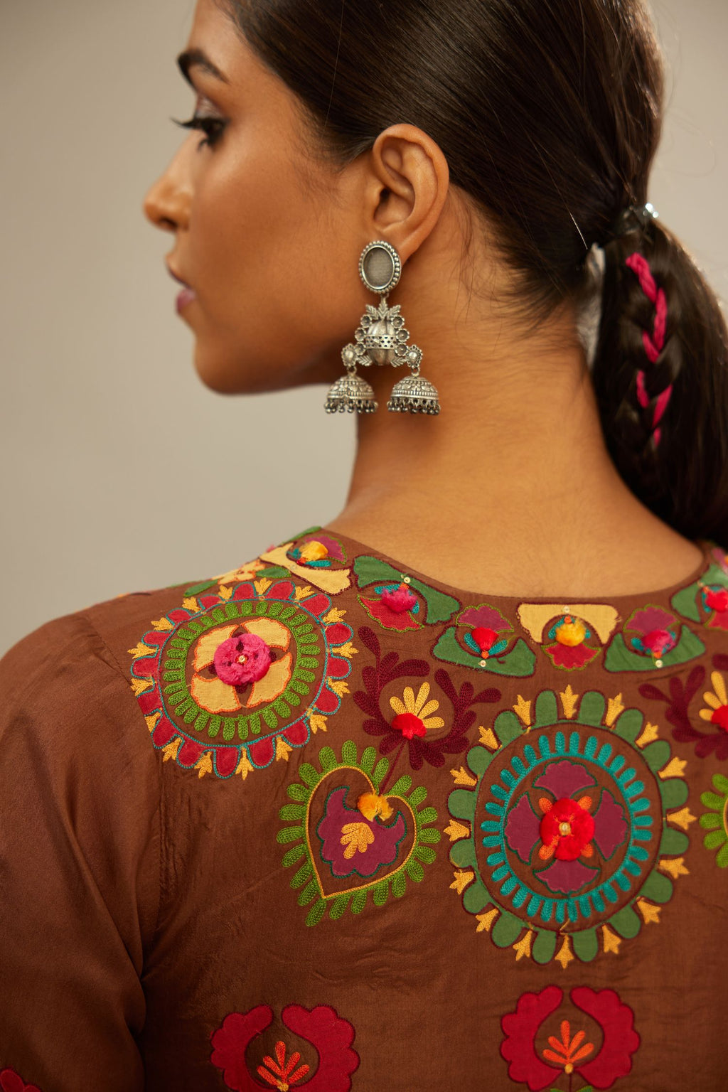 Brown silk straight hem mid-length abha style kurta set with bold appliqué embroidery along with multi-colored aari thread work and tassels.