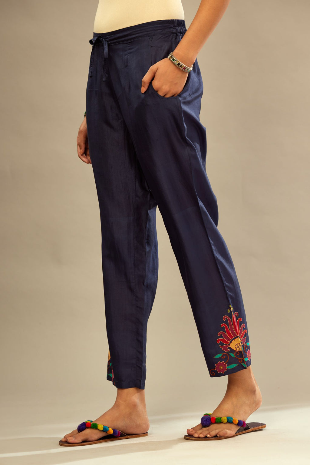 Indigo silk straight pants with multi colored appliqué at hem.
