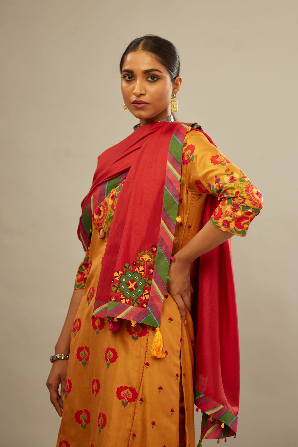 Mustard kalidar straight kurta set, fully embroidered with appliqué flowers, multi-colored aari threadwork and silk tassels.